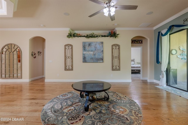 sitting room featuring light hardwood / wood-style floors, ceiling fan, and crown molding