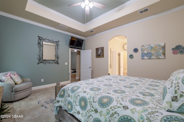 bedroom with ornamental molding, ceiling fan, and a raised ceiling