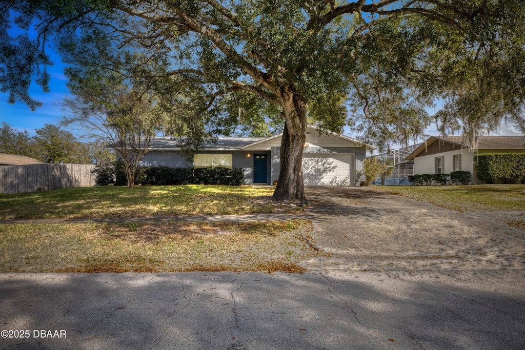 single story home with a garage and a front yard