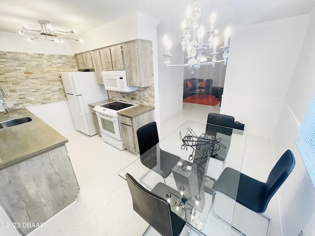 840 Center Ave Unit 840, Daytona Beach, FL 32117 - kitchen with white appliances, a chandelier, a sink, decorative backsplash, and light countertops