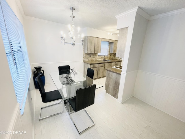 840 Center Ave Unit 840, Daytona Beach, FL 32117 - dining area with a chandelier, wainscoting, light wood finished floors, a textured ceiling, and ornamental molding