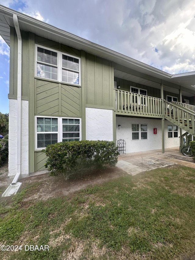 840 Center Ave Unit 840, Daytona Beach, FL 32117 - view of side of property featuring a patio area, board and batten siding, and stucco siding