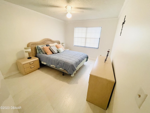 840 Center Ave Unit 840, Daytona Beach, FL 32117 - bedroom with ornamental molding, a textured ceiling, baseboards, light wood-style floors, and a ceiling fan
