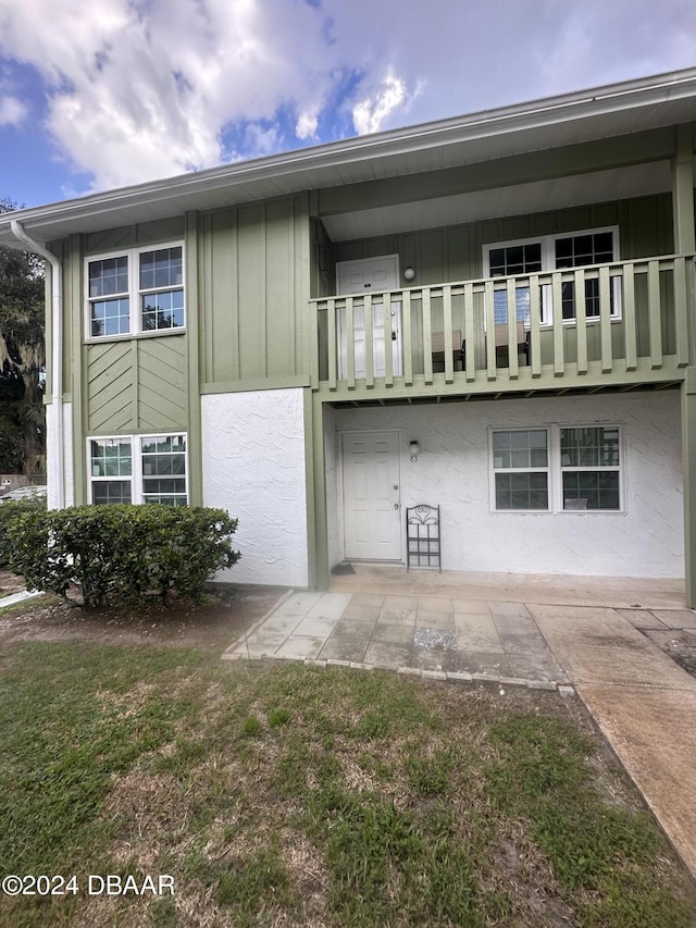 840 Center Ave Unit 840, Daytona Beach, FL 32117 - rear view of property featuring board and batten siding and a balcony