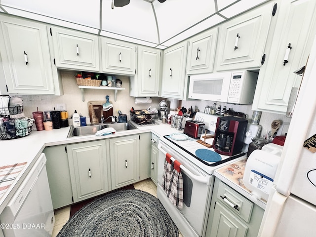 kitchen featuring white cabinetry, sink, white appliances, and light tile patterned floors