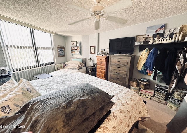 carpeted bedroom with ceiling fan and a textured ceiling