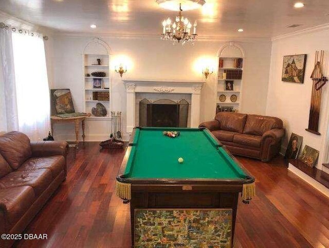 220 John Anderson Dr, Ormond Beach, FL 32176 - playroom featuring built in shelves, billiards, wood finished floors, a fireplace, and crown molding