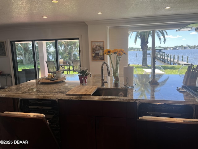 220 John Anderson Dr, Ormond Beach, FL 32176 - kitchen featuring crown molding, stone countertops, a textured ceiling, a sink, and recessed lighting