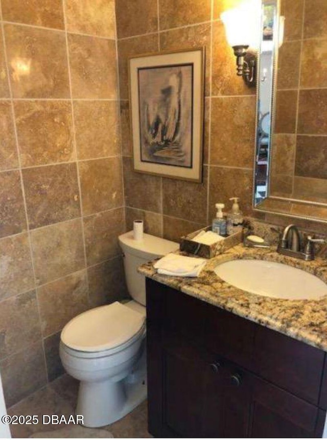 220 John Anderson Dr, Ormond Beach, FL 32176 - bathroom with tile walls, vanity, and toilet