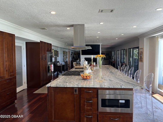 220 John Anderson Dr, Ormond Beach, FL 32176 - kitchen with a textured ceiling, light stone counters, recessed lighting, a large island, and dark wood-type flooring