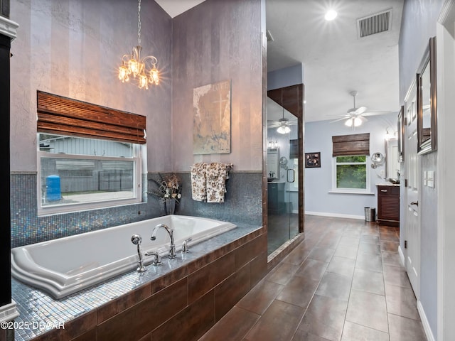 full bathroom featuring ceiling fan with notable chandelier, visible vents, a shower stall, a bath, and tile patterned floors