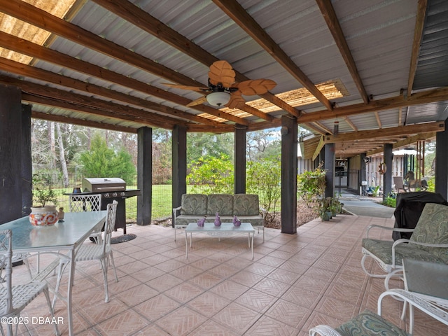 view of patio with a ceiling fan, outdoor dining space, an outdoor living space, and grilling area