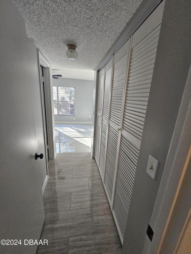 corridor featuring a textured ceiling