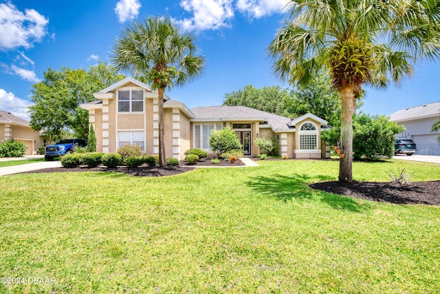 view of front of property featuring a garage and a front yard