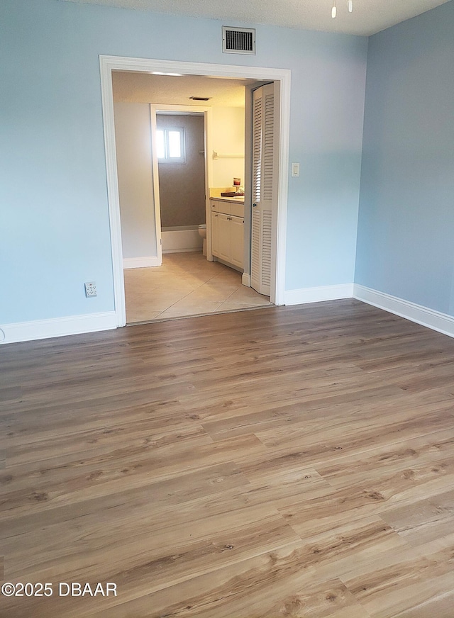 100 Silver Beach Ave Unit 308, Daytona Beach, FL 32118 - spare room featuring light wood-type flooring, visible vents, and baseboards