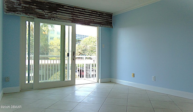 100 Silver Beach Ave Unit 308, Daytona Beach, FL 32118 - empty room with crown molding, expansive windows, tile patterned flooring, and baseboards