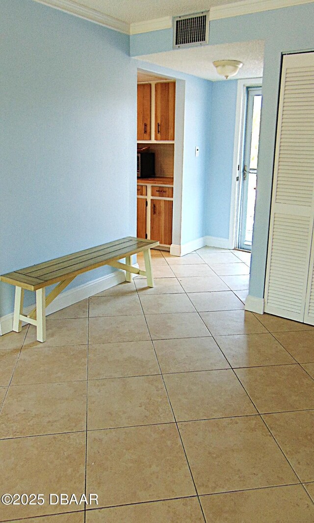 100 Silver Beach Ave Unit 308, Daytona Beach, FL 32118 - tiled spare room featuring visible vents, crown molding, and baseboards