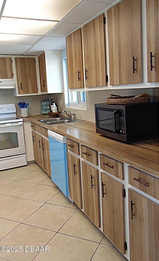 100 Silver Beach Ave Unit 308, Daytona Beach, FL 32118 - kitchen with white electric range oven, light tile patterned floors, butcher block counters, under cabinet range hood, and dishwashing machine