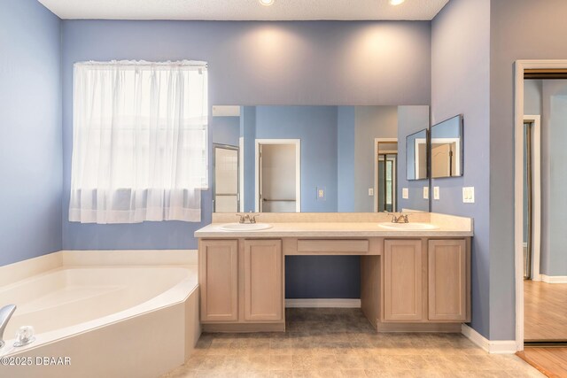 tiled spare room featuring sink, ceiling fan, a high ceiling, and a textured ceiling