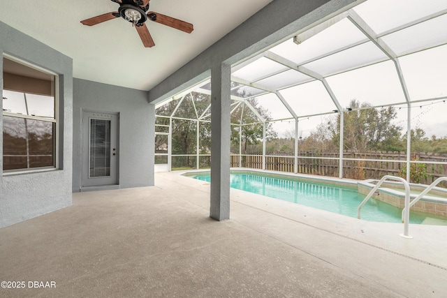 view of pool featuring ceiling fan, a patio, and a lanai