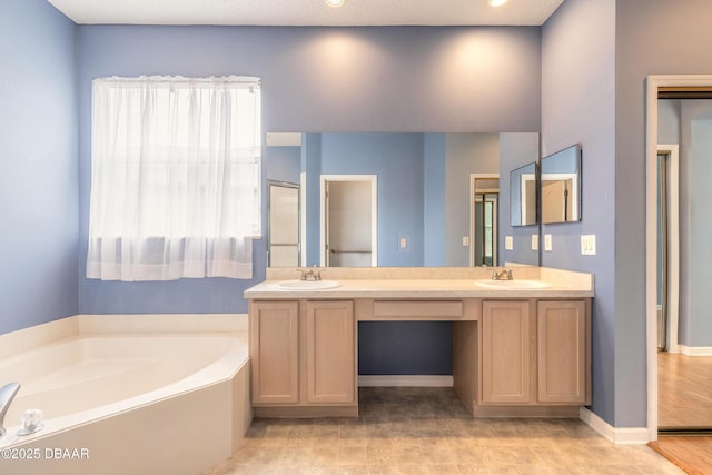 bathroom with vanity and a washtub