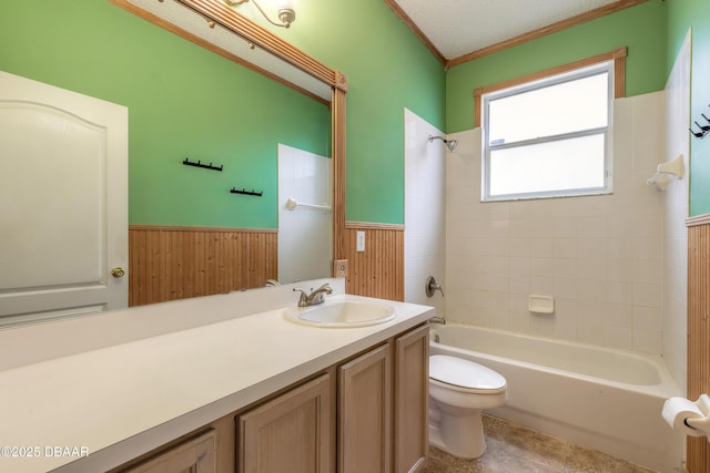 full bathroom featuring tiled shower / bath, a textured ceiling, toilet, vanity, and wood walls