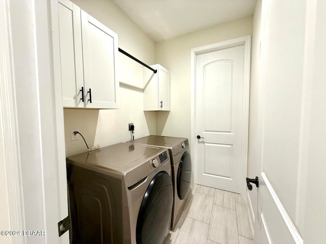 laundry area featuring cabinets and separate washer and dryer