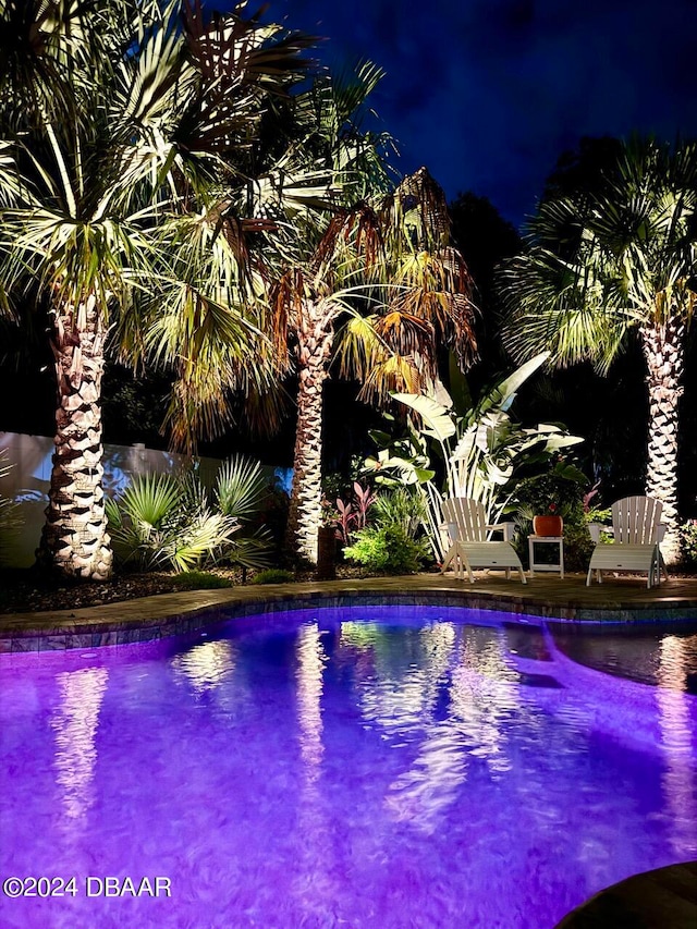 view of pool at night