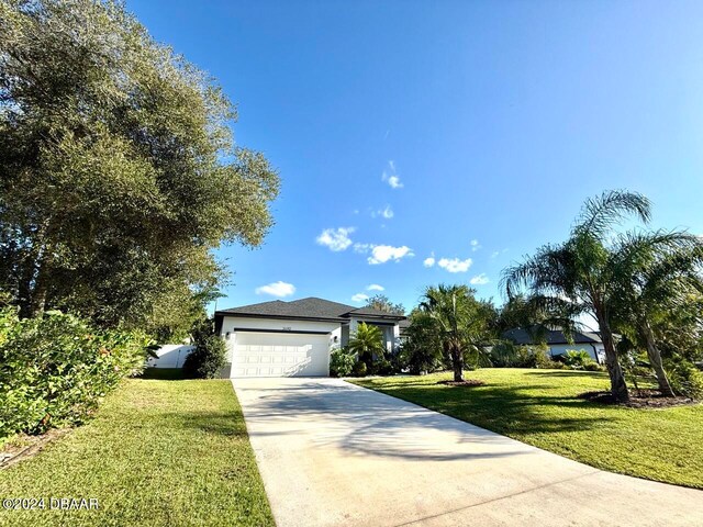 ranch-style home featuring a garage and a front yard