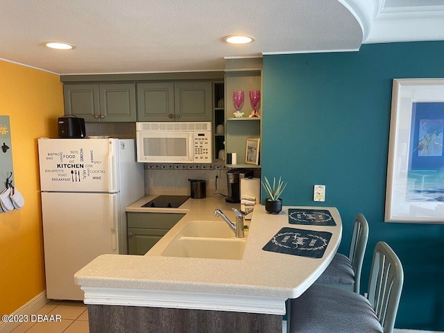 2700 N Atlantic Ave Unit 901, Daytona Beach, FL 32118 - kitchen with sink, kitchen peninsula, tasteful backsplash, light tile patterned floors, and white appliances