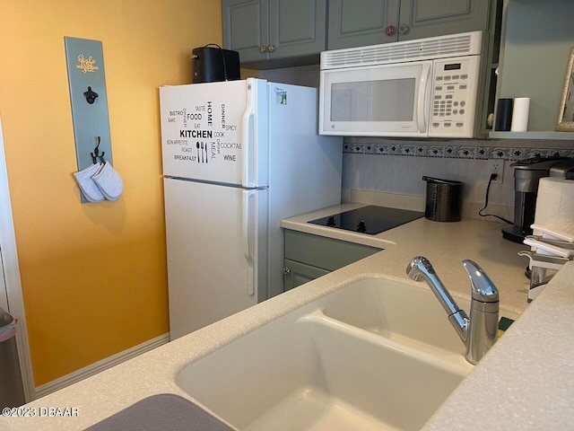 2700 N Atlantic Ave Unit 901, Daytona Beach, FL 32118 - kitchen with white appliances, sink, and decorative backsplash