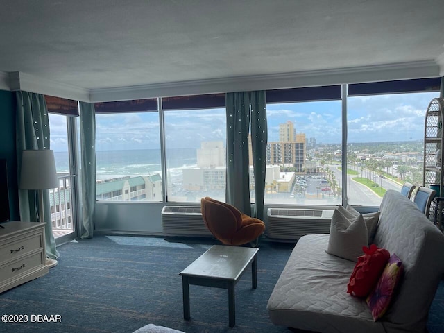 2700 N Atlantic Ave Unit 901, Daytona Beach, FL 32118 - carpeted living room featuring a water view, a wall mounted air conditioner, and crown molding