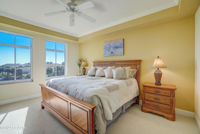 bedroom featuring ornamental molding, light carpet, and ceiling fan