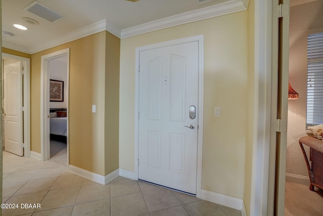 entrance foyer featuring light tile patterned floors and crown molding