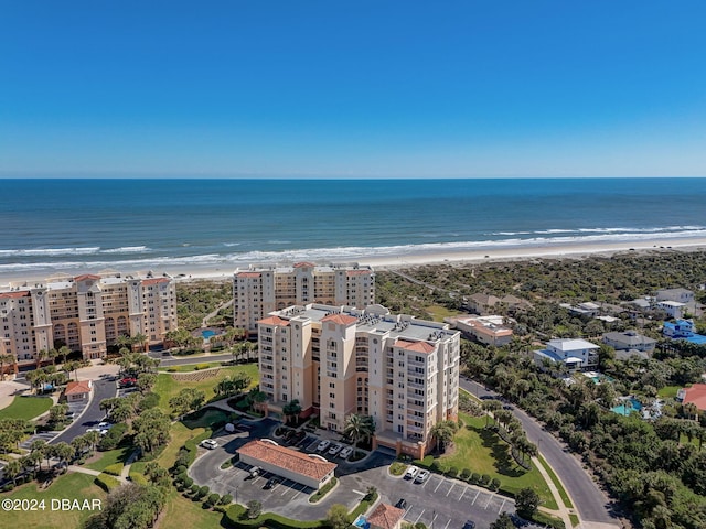 birds eye view of property with a beach view and a water view