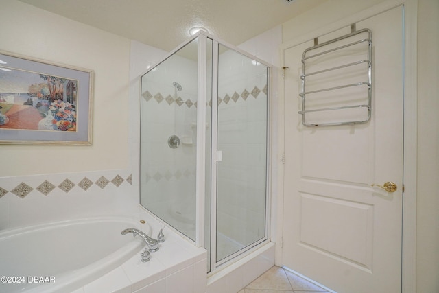 bathroom featuring tile patterned flooring and shower with separate bathtub