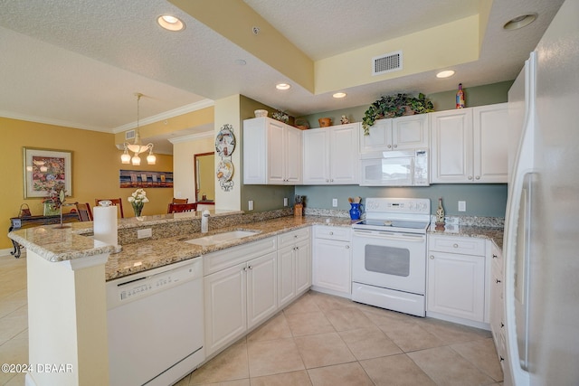 kitchen with white cabinets, white appliances, sink, and kitchen peninsula