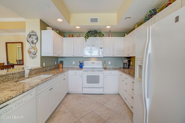 kitchen featuring white cabinetry, light stone counters, sink, and white appliances