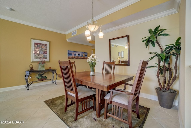 tiled dining area with a textured ceiling, a notable chandelier, and ornamental molding