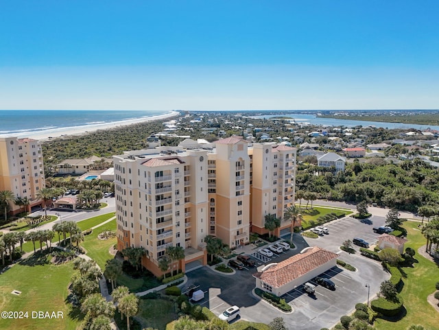 birds eye view of property featuring a beach view and a water view