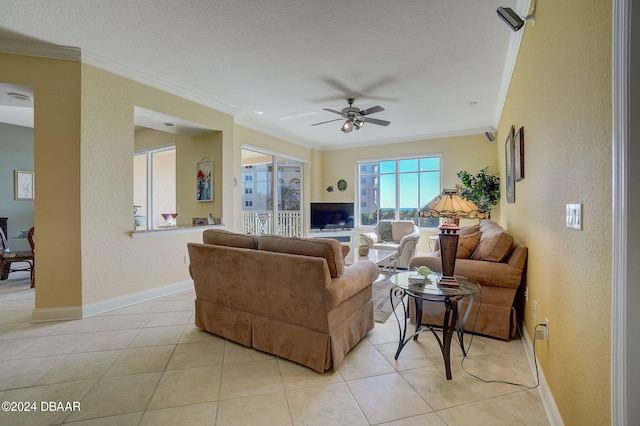 tiled living room featuring ornamental molding and ceiling fan