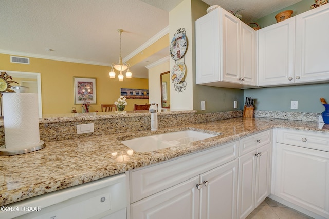 kitchen featuring white cabinetry, sink, and crown molding