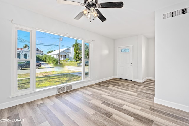 entrance foyer featuring a ceiling fan, wood finished floors, visible vents, and baseboards