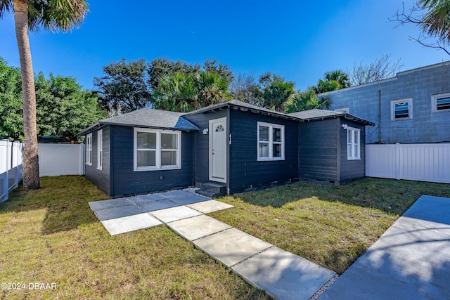 view of front of home featuring fence private yard and a front yard