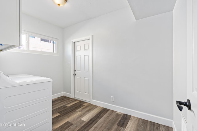 clothes washing area with dark wood-style floors, laundry area, washer and clothes dryer, and baseboards