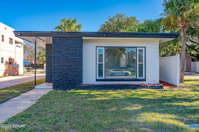 exterior space with a front yard and fence