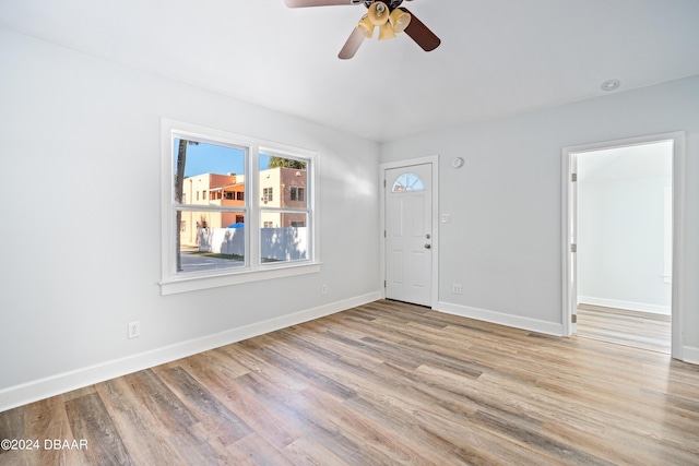 spare room with ceiling fan, baseboards, and wood finished floors