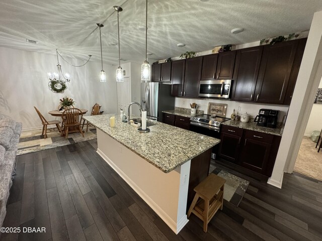 31 Ridge Rd, Palm Coast, FL 32137 - kitchen with stainless steel appliances, a sink, a center island with sink, baseboards, and dark wood-type flooring