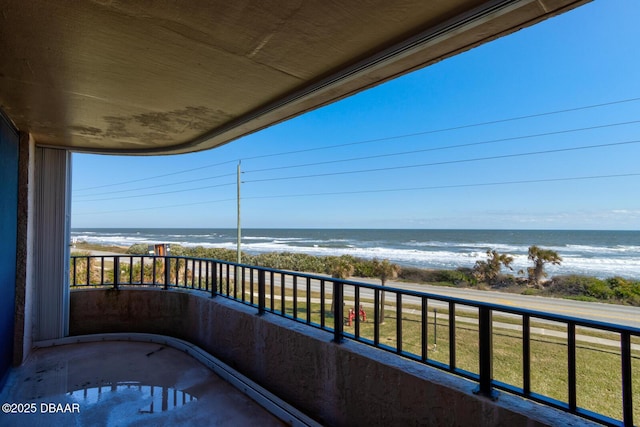 balcony featuring a water view and a beach view