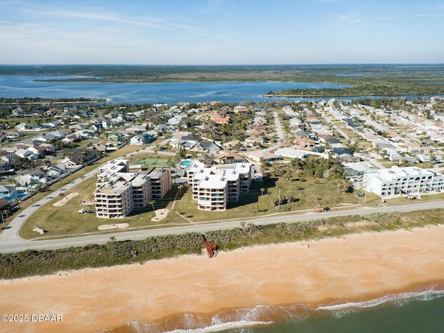 birds eye view of property featuring a water view and a view of the beach